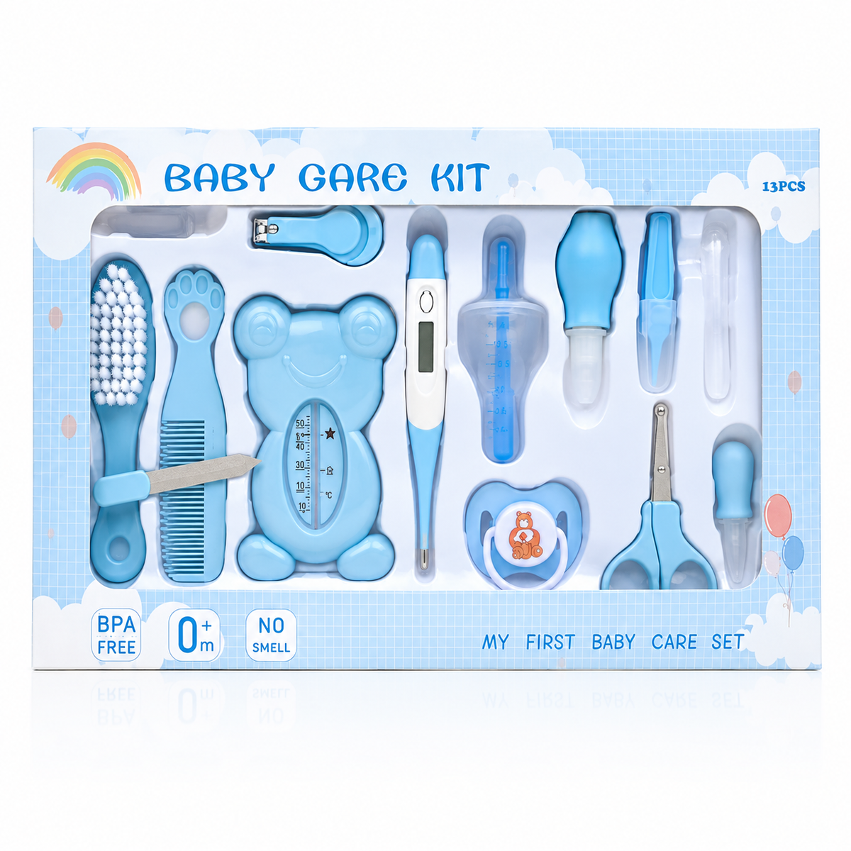 A baby care kit in its retail packaging, featuring various baby care tools such as a hairbrush, nail clipper, thermometer, pacifier clip, and nipple shield in light blue and white, with a rainbow graphic on a white and blue cloud-patterned box.
