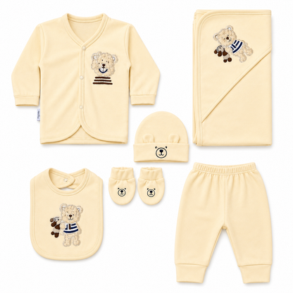 Baby clothing set with yellow outfit, hat, bib, gloves, and pants featuring teddy bear designs on a white background.