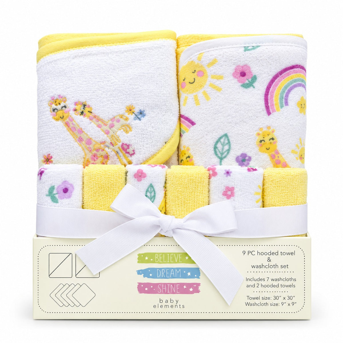 A 9-piece baby towel and washcloth set by Baby Elements, featuring yellow and white hooded towels with giraffes, a rainbow, and suns, tied with a white ribbon in its cream-colored packaging box.