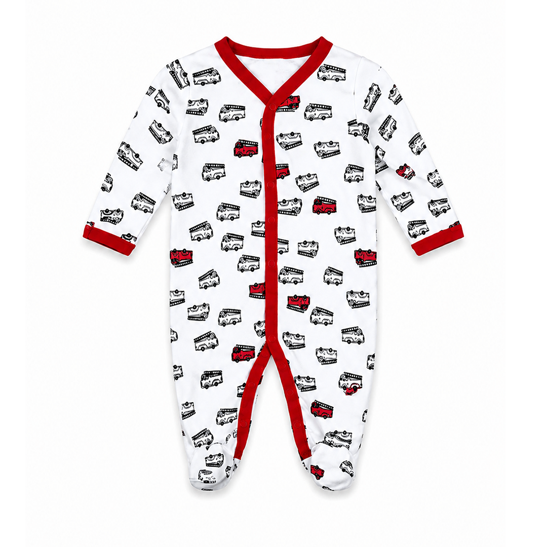 A baby long-sleeve footed sleeper in white, featuring an all-over black and red double-decker bus pattern, with red trim along the collar, snap closure, cuffs, and crotch.