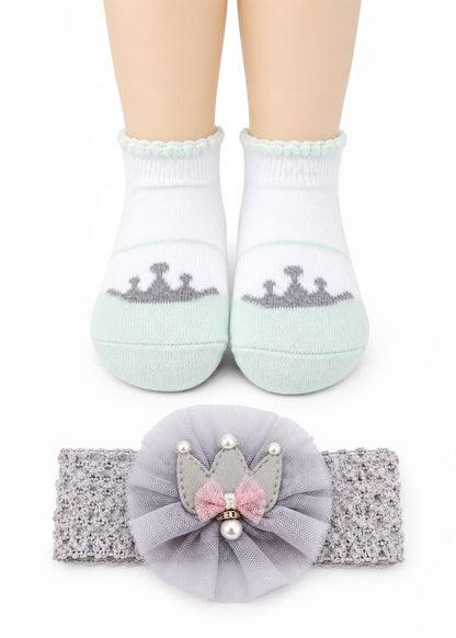 Children's socks with crowns and a matching headband on a white background