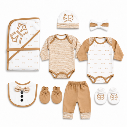 A coordinated baby clothing set laid out on a white background, including a patterned wrap blanket, long-sleeve bodysuit, pants, bib, booties, socks, and hat, all in warm tan and white with small repeating logo motifs.
