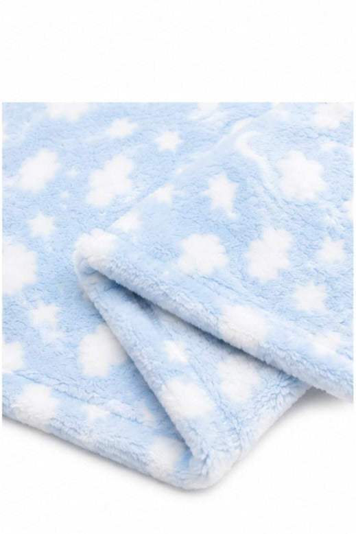 A close-up of a soft, plush blanket or throw in light blue with a white star pattern, folded to show its texture.