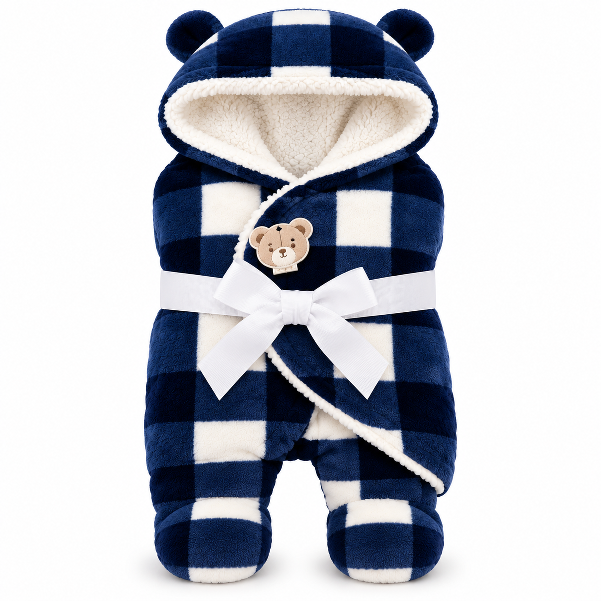 A baby footed robe in a navy and white checkered pattern with a plush cream sherpa lining, featuring bear ears on the hood, a white ribbon belt with a bow, and a small teddy bear patch on the chest.