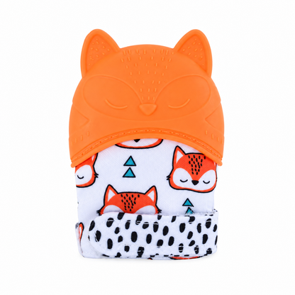 An orange silicone baby teether with cat ears and a sleeping face design, attached to a white fabric neck wrap printed with cartoon foxes and black spots.