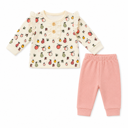 Baby outfit with patterned top and pink pants on a white background