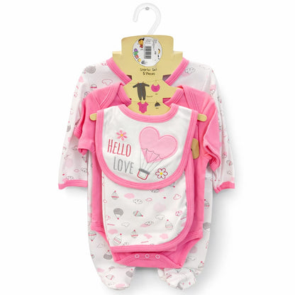 Baby clothing set with onesie, bib, and pants on a hanger against a white background
