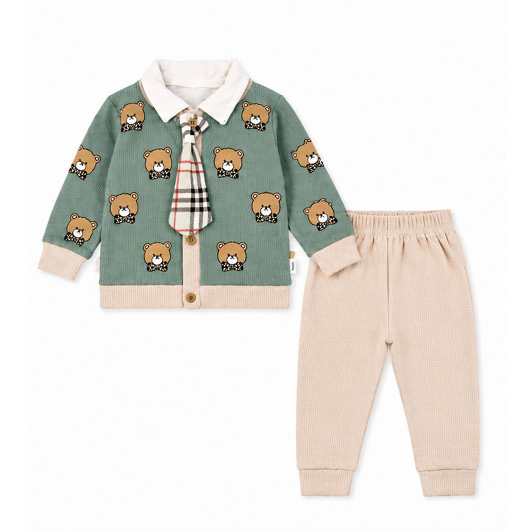 Baby outfit with green cardigan, beige pants, and plaid tie on a white background