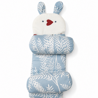 A bunny-shaped sleeping bag or pouch with a hood, featuring a light blue and white leaf pattern, white bunny face and feet, and small red heart and eye details, shown on a plain white background.