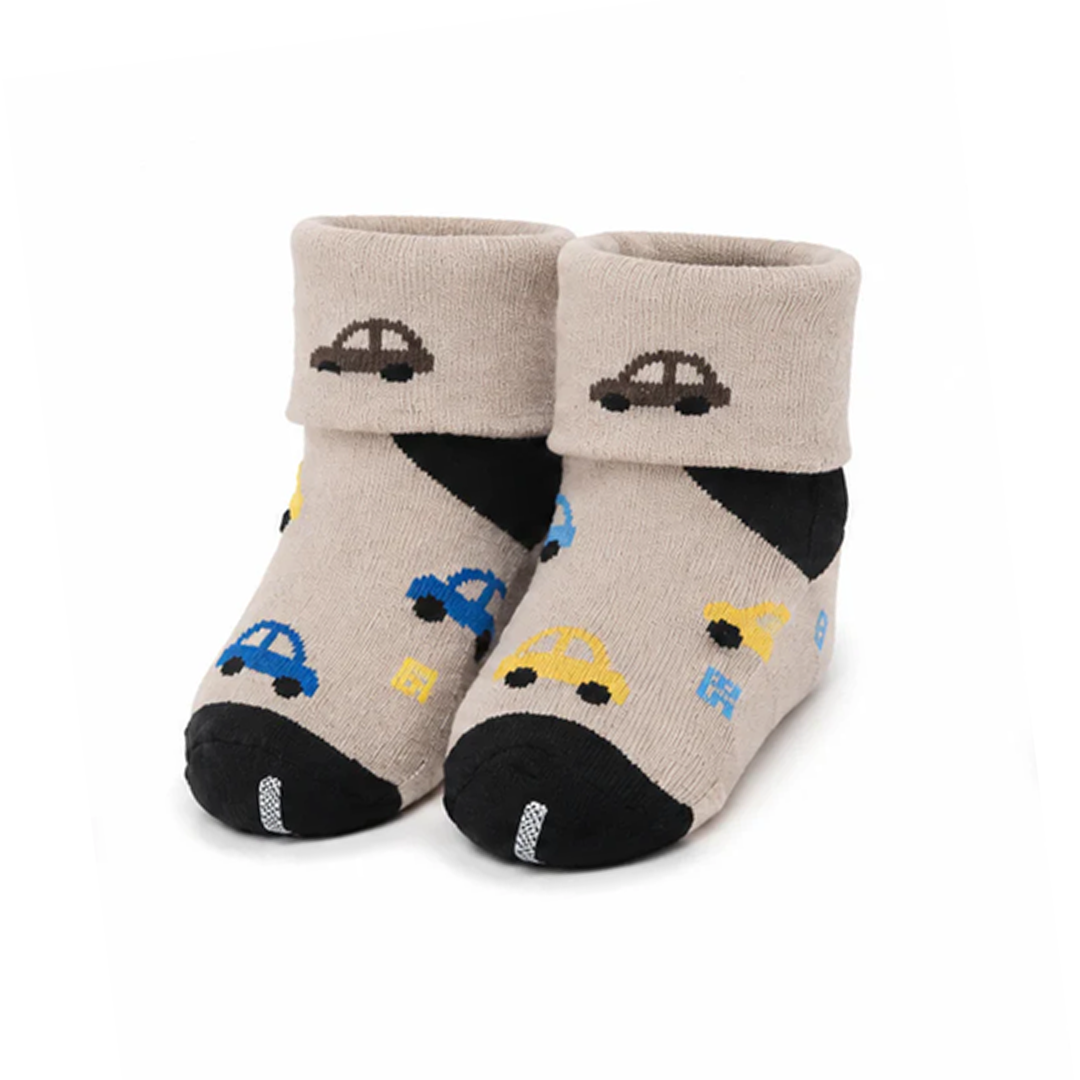 A pair of beige baby socks with black heels and toes, decorated with small colorful car and sun motifs, shown on a plain white background.