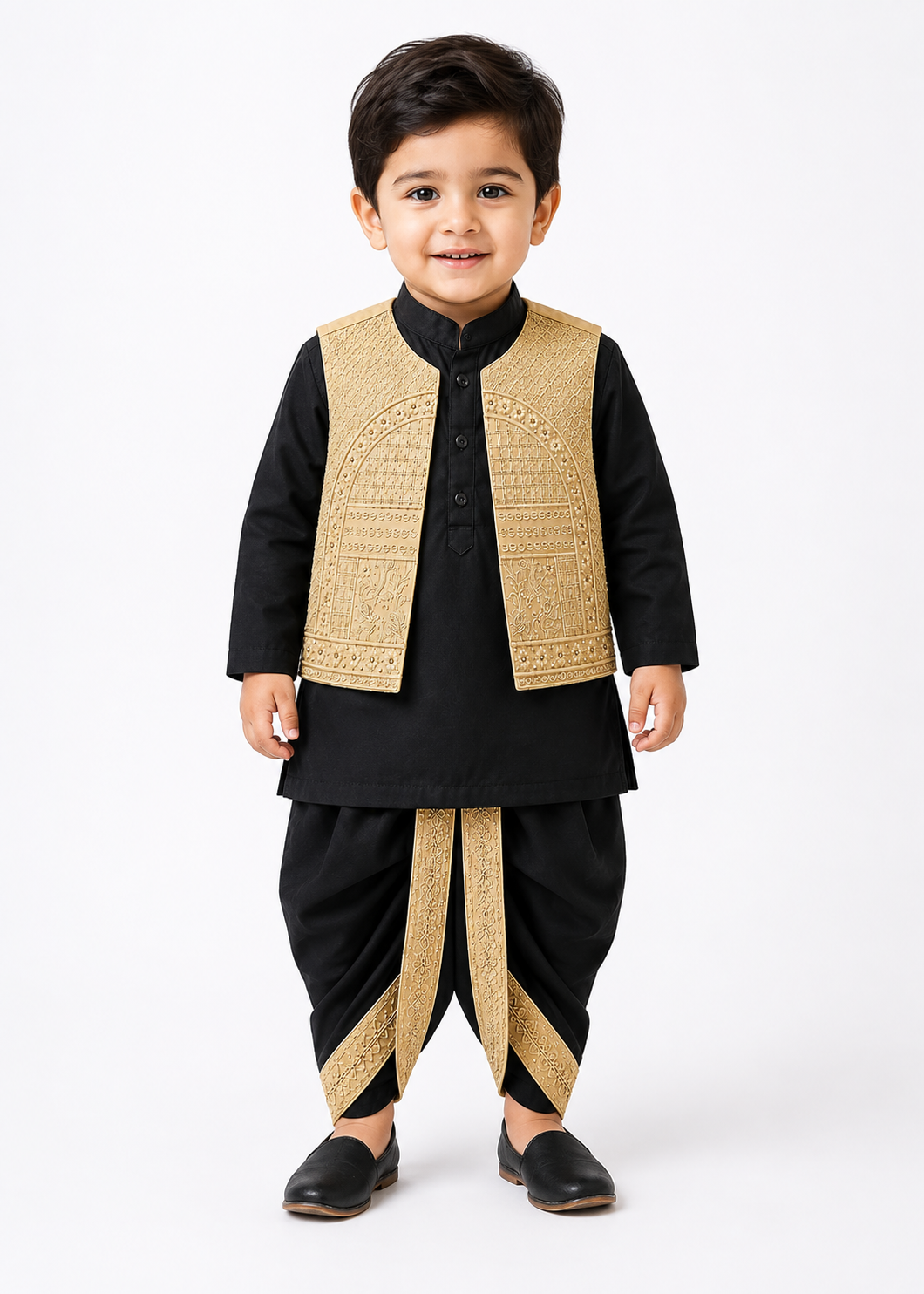 A young boy modeling a traditional Indian outfit consisting of a black kurta and dhoti pants with gold embroidered details on the vest and waist sash, set against a plain white studio background.