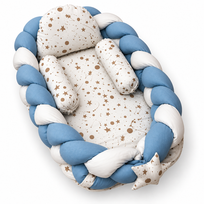 Angled view of blue and white braided baby snuggle bed with matching star print pillow and two neck rolls by BabyCo Pakistan