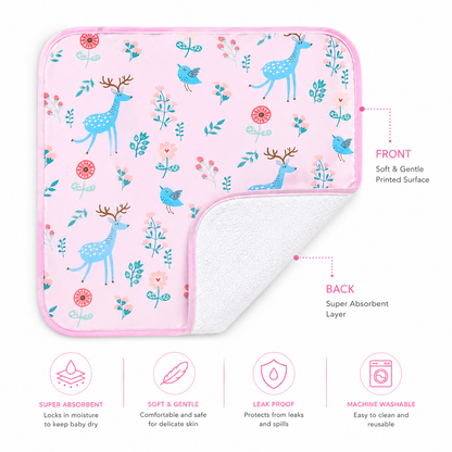 A square baby diaper changing sheetl with a pink border and a whimsical deer, bird, and floral print on a light pink front, shown with the corner folded over to reveal a white absorbent back. Text labels identify the front and back, and four feature icons at the bottom list super absorbency, softness, leak proof protection, and machine washability.