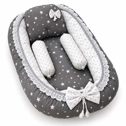 Angled grey star print baby snuggle bed with matching pillow, two neck rolls and lace trim by BabyCo Pakistan
