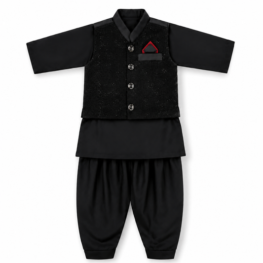 A baby boy's traditional Pakistani outfit consisting of a black long-sleeve kurta with a textured black waistcoat, black pants, and a small red pocket square accent.