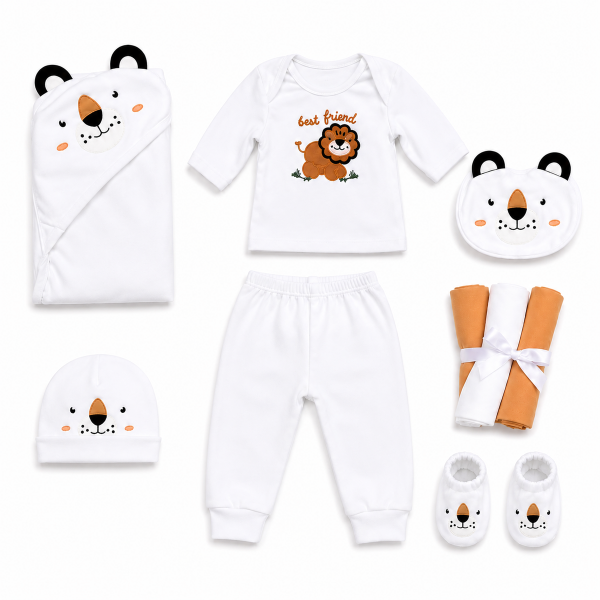 A coordinated baby outfit set laid out on a white background, featuring a white long-sleeve top with a lion graphic and the words 'best friends,' white pants, a white hooded wrap, a white eye mask, a white beanie, and white booties, all decorated with cute bear faces. Two rolled fabric pieces in orange and white with a white ribbon are also included.