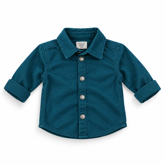 A toddler's long-sleeve button-up shirt in teal denim, featuring a pointed collar, silver snap buttons, and rolled cuffs, shown flat on a white background.