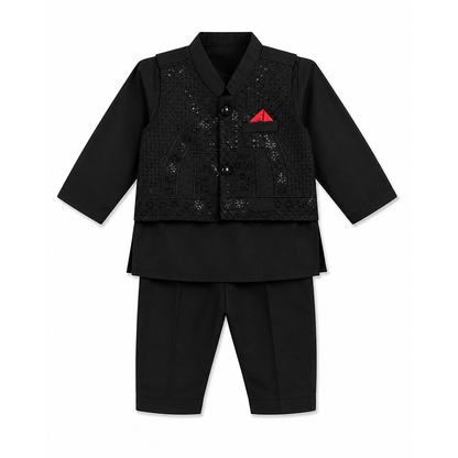 A black traditional outfit set for a child, featuring a long-sleeve collared jacket with textured embroidery and a small red pocket square, paired with matching black trousers, shown on a plain white background.