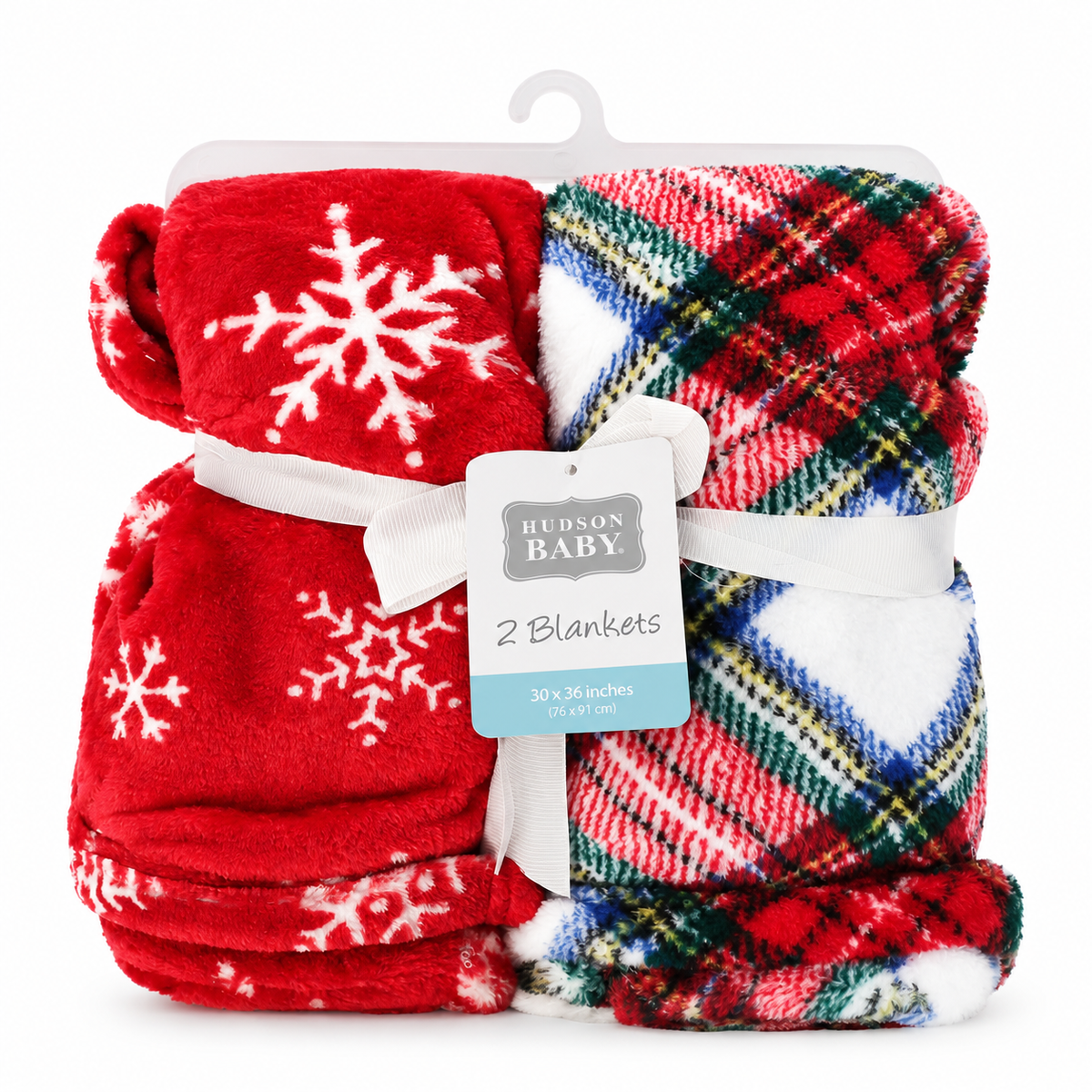 A packaged set of two folded blankets on a white background. One blanket is bright red with white snowflakes, and the other is a multicolor plaid with red, green, blue, yellow, and white.