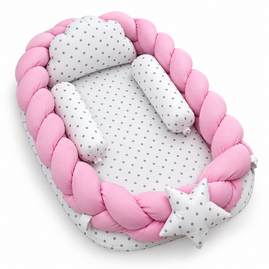 Angled view of pink braided baby snuggle bed with matching pillow and two neck rolls by BabyCo Pakistan