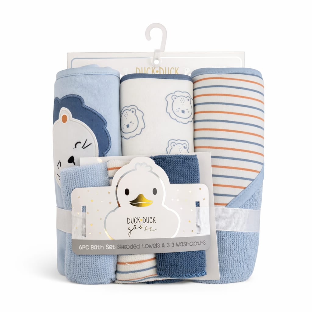 A 6-piece baby bath set by Duck Duck Goose, including three swaddle towels and three washcloths, packaged on a white hanger card. The towels and washcloths feature light blue, navy blue, white, and orange stripes, with cartoon duck, bear, and lion patterns.