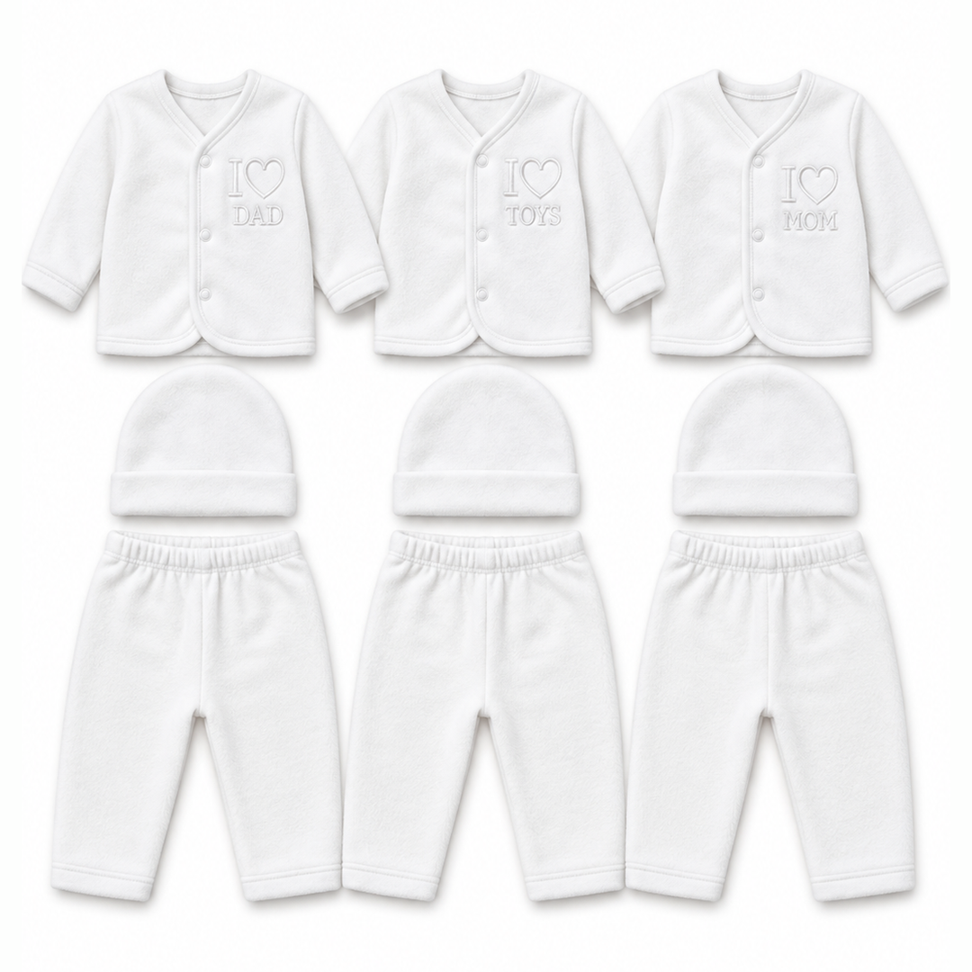 Six white baby clothing sets arranged in two rows on a plain white background. The top row shows long-sleeve button-front cardigans with embroidered text reading 'I [heart] DAD', 'I [heart] TOYS', and 'I [heart] MOM', paired with matching beanies.